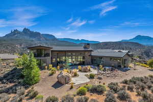 Rear view of property featuring a mountain view and a patio area