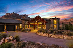 View of front of property featuring a garage and a mountain view