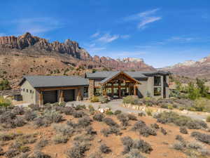 View of front of home with a garage and a mountain view