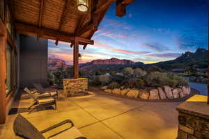 Patio terrace at dusk featuring a mountain view