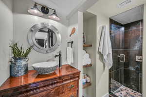 Bathroom with sink and a shower with door