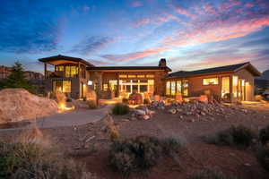 Back house at dusk with a balcony