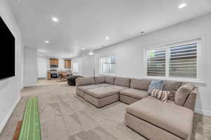 Living room featuring a textured ceiling and light colored carpet