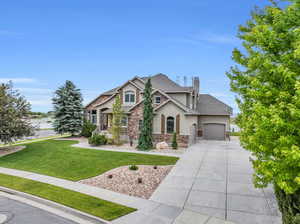 Craftsman inspired home featuring a front yard and a garage