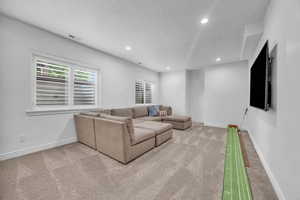 Living room featuring a textured ceiling and light colored carpet