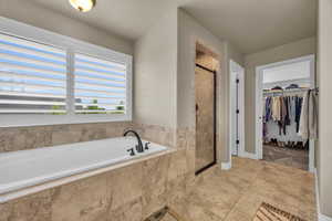 Bathroom featuring shower with separate bathtub