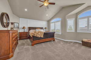 Bedroom featuring lofted ceiling, ceiling fan, and light colored carpet