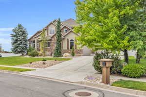 View of front of home featuring a front yard and a garage