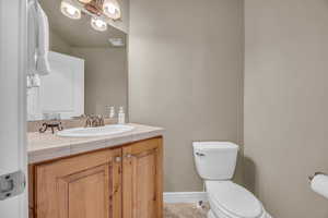 Bathroom with tile patterned floors, vanity, and toilet