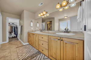 Bathroom featuring tile patterned flooring and vanity