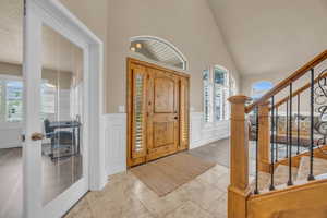 Foyer featuring lofted ceiling and light hardwood / wood-style flooring