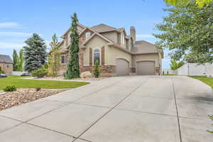 View of front of house featuring a front yard and a garage