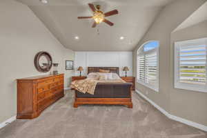 Bedroom with light carpet, vaulted ceiling, and ceiling fan