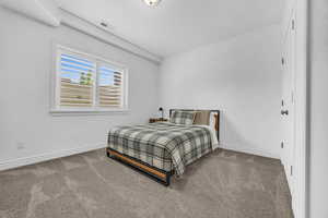 Carpeted bedroom featuring a textured ceiling