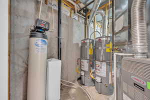 Utility room featuring gas water heater and heating unit