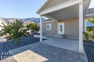 Covered patio on west side of home looking northeast. Peach tree in left foreground.