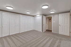 Basement with light carpet