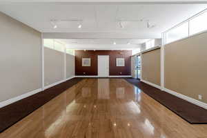 Interior space with hardwood / wood-style flooring and track lighting