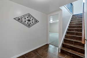 Staircase with tile patterned floors