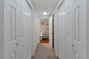 Hallway with light colored carpet