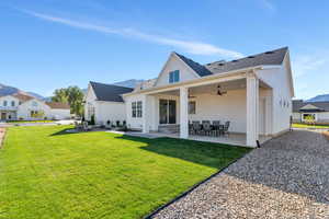 Back of house featuring a lawn, a patio, and ceiling fan