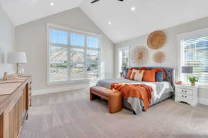 Primary bedroom with lofted ceiling and ceiling fan