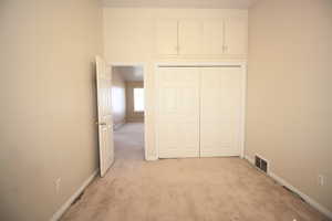 Bedroom 2 featuring light carpet and a closet