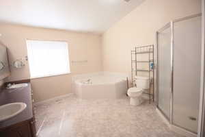 Full Master bathroom featuring separate shower and jetted tub, vanity, and toilet