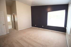 Carpeted Master Bedroom with vaulted ceiling