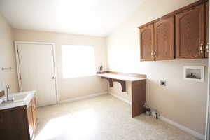 Laundry room with washer hookup, cabinets, light colored carpet, sink, and electric dryer hookup