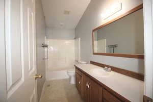 Full bathroom featuring shower / washtub combination, vanity, and toilet