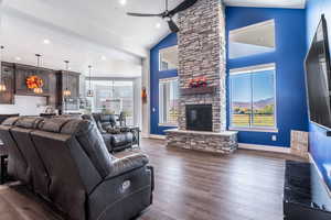 Living room with a healthy amount of sunlight, and stunning fireplace