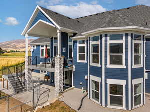 Rear view of house with a patio and a mountain view