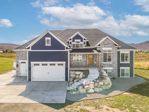 Custom built house with a mountain view and a 3 car garage