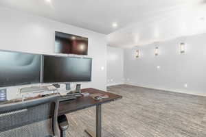 Carpeted office with a textured ceiling