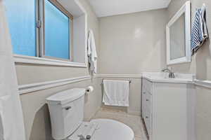 Bathroom featuring tile patterned floors, vanity, and toilet