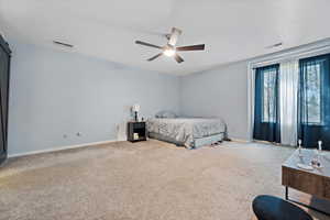 Bedroom with ceiling fan and carpet