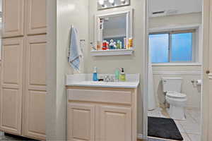 Bathroom with vanity, toilet, and tile patterned floors