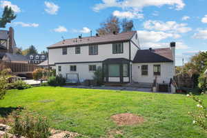 Back of property with a patio and a yard