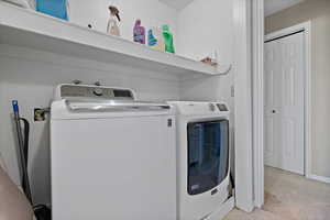 Laundry room featuring washer and clothes dryer