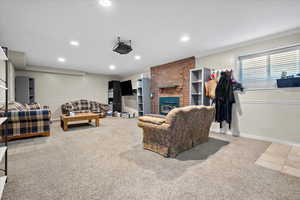 Carpeted living room featuring crown molding and a fireplace