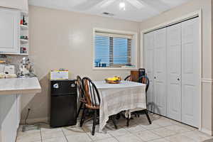 Tiled dining area with ceiling fan