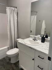 Full bathroom with vanity, toilet, and shower / tub combo