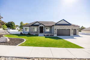 View of front of home featuring a front yard and a garage