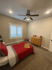 Carpeted bedroom with ceiling fan