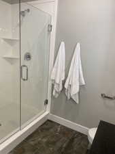 Bathroom with toilet and a shower with door