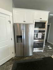 Kitchen featuring white cabinetry and stainless steel appliances