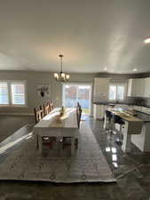 Unfurnished dining area with a notable chandelier