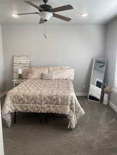 Carpeted bedroom featuring ceiling fan