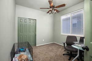 Office area with light carpet and ceiling fan